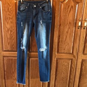 Mid-rise shredded skinny jeans